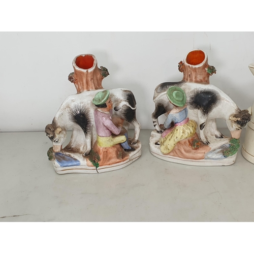 19 - A plaster Model of a Dachshund, a pair of Staffordshire Dairy Girl and Cow Vases, two antique Jugs w... 