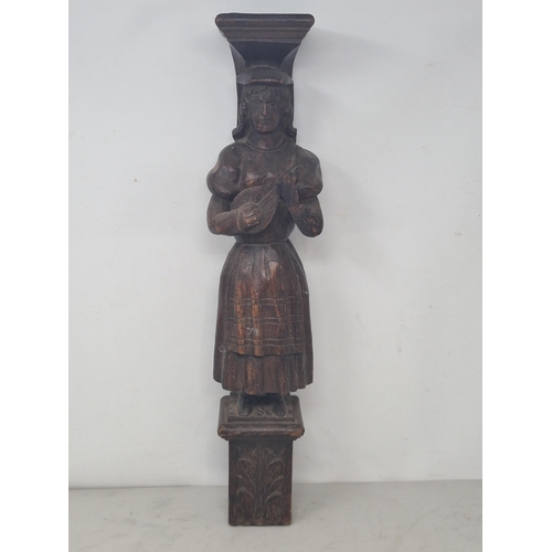 23 - An antique carved oak Figural Term in the form of a female lute player A/F 1ft 7 1/2in H (R3)