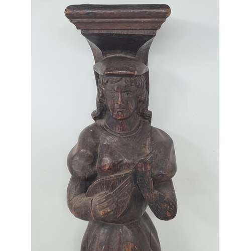 23 - An antique carved oak Figural Term in the form of a female lute player A/F 1ft 7 1/2in H (R3)