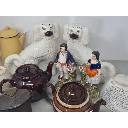 24 - A pair of Staffordshire seated Spaniels, another pair of Staffordshire Figures of a lady and gentlem... 