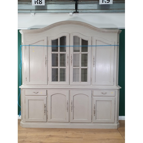 28 - A large grey painted continental Cupboard, the top section with shaped cornice above pair of glazed ... 