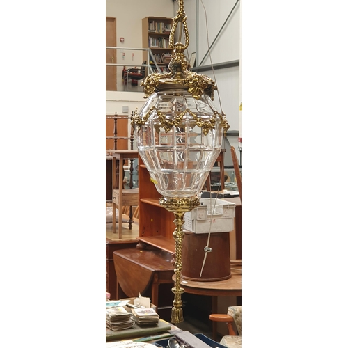 301A - A gilt metal Hanging Ceiling Light with rope twist and floral designs, having a panelled cut glass b... 