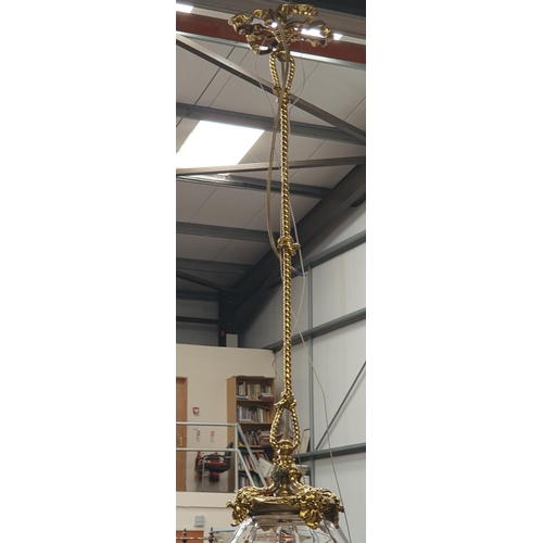 301A - A gilt metal Hanging Ceiling Light with rope twist and floral designs, having a panelled cut glass b... 