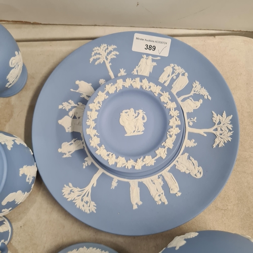 389 - A collection of blue Wedgewood Jasperware including Plates, Dishes, Vases, Trinket Boxes, etc. (R5).