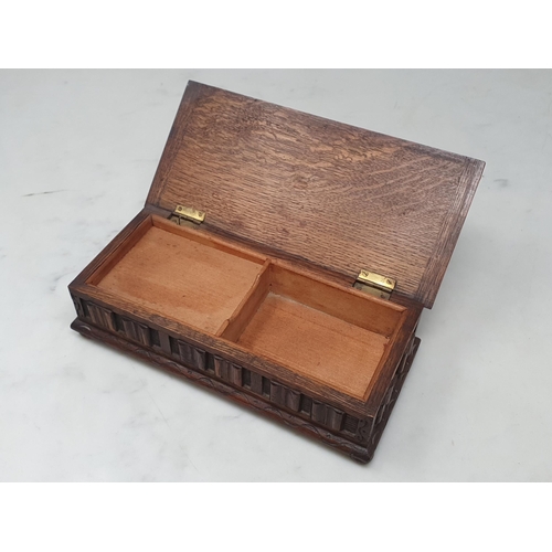 150A - A carved oak musical Jewellery Box, the lid with carved oval motif above applied linen fold decorati... 