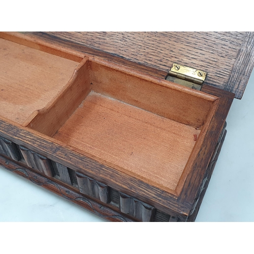 150A - A carved oak musical Jewellery Box, the lid with carved oval motif above applied linen fold decorati... 