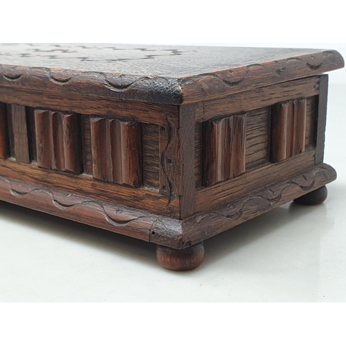 150A - A carved oak musical Jewellery Box, the lid with carved oval motif above applied linen fold decorati... 