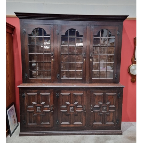 46 - A large oak glazed Bookcase fitted adjustable shelves, the base fitted panelled cupboard doors, 7ft ... 