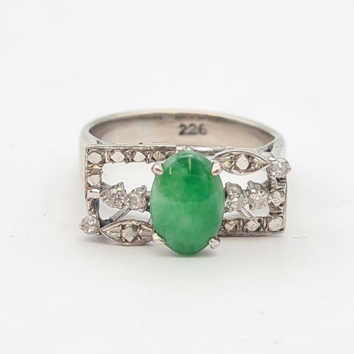 157 - A Jade and Diamond Ring claw-set oval jade between trios of eight-cut diamonds in white metal, stamp... 