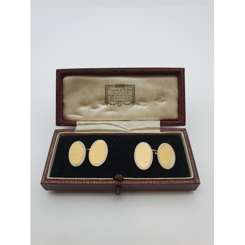 161 - A pair of white and yellow gold oval Cufflinks with engraved decoration, stamped 18ct, approx 12.70g... 