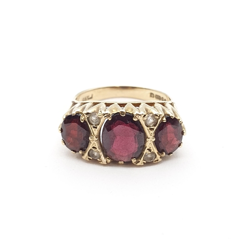 163 - A Garnet three stone Ring pavé-set oval-cut stones in 9ct gold, ring size M, approx 3.80gms