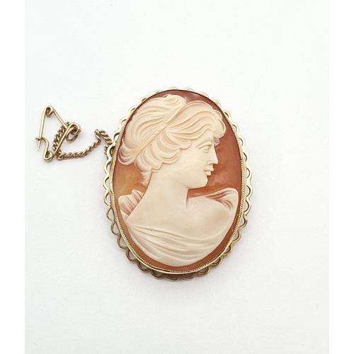 172 - A carved shell Cameo Brooch of classical bust in profile in gold scalloped frame marked 9ct