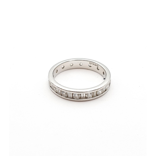 176 - A Diamond Eternity Ring channel-set alternating baguette and brilliant-cut stones in platinum, ring ... 