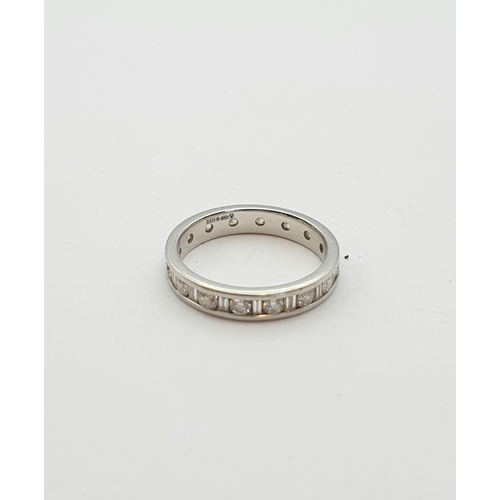 176 - A Diamond Eternity Ring channel-set alternating baguette and brilliant-cut stones in platinum, ring ... 