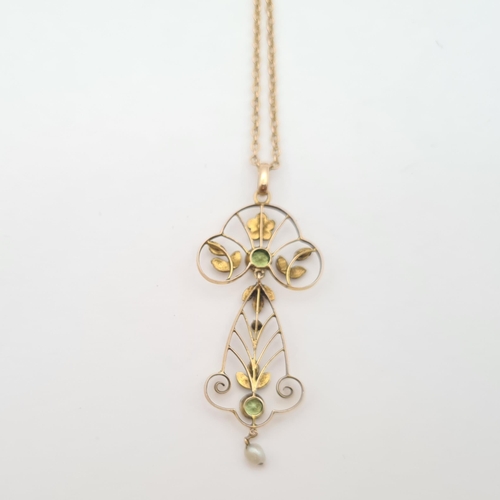 177 - An Art Nouveau Peridot and Seed Pearl Pendant millegrain-set two round peridot and two seed pearls t... 