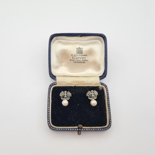 180 - A pair of Cultured Pearl and Marcasite Earrings in silver, on screw fittings