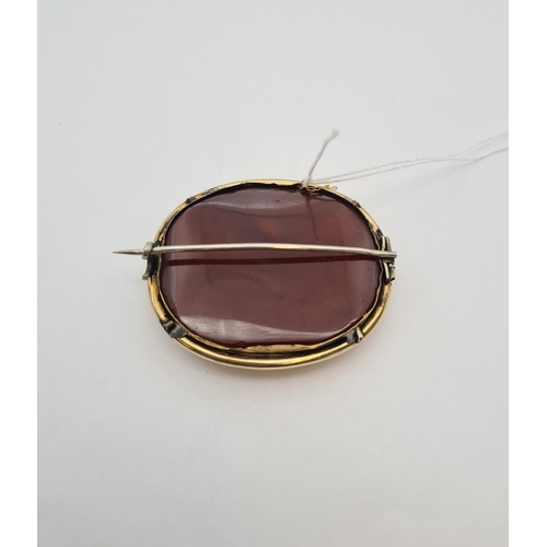 223 - An oval Brooch set carnelian in yellow metal frame