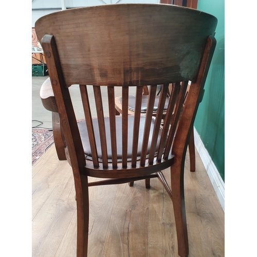 10 - A near pair of 1920's beech framed Office Elbow Chairs with leather style brown upholstered seats, o... 