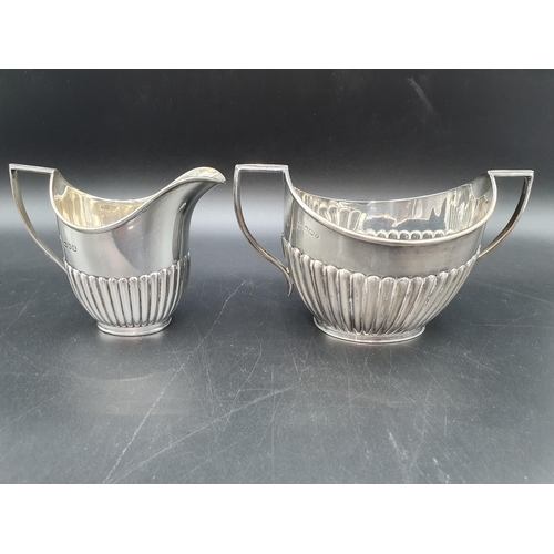 105 - A Victorian silver Milk Jug and Sugar Bowl of oval semi-fluted form, Sheffield 1897 and London 1900,... 