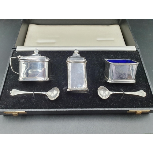 120 - A George V silver three piece Condiment Set, Birmingham 1930, and two small trefid Salt Spoons, Birm... 