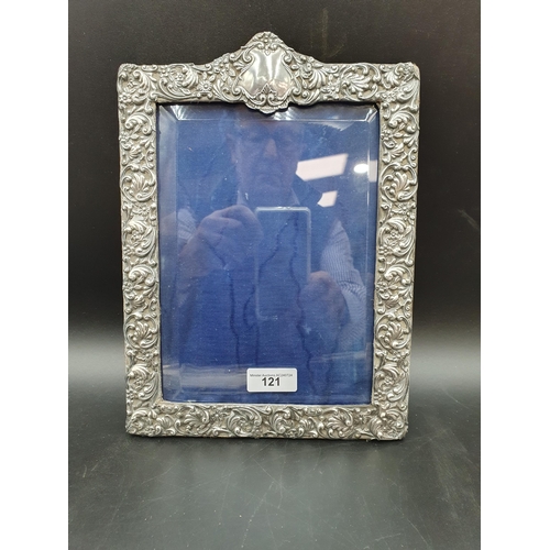 121 - An Edward VII silver Photograph Frame with floral and scroll embossing, Birmingham 1903, 11 x 8in