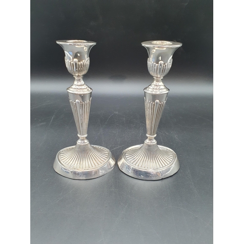 129 - A pair of Victorian silver Candlesticks with fluted tapering columns on oval bases, Birmingham 1898,... 