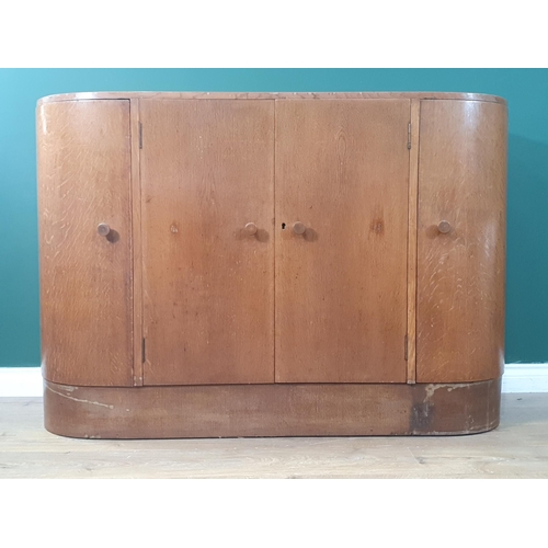 16 - A Heals Art Deco bow front Sideboard fitted four cupboard doors, the central doors enclosing three f... 