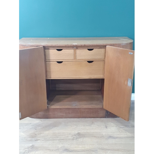 16 - A Heals Art Deco bow front Sideboard fitted four cupboard doors, the central doors enclosing three f... 