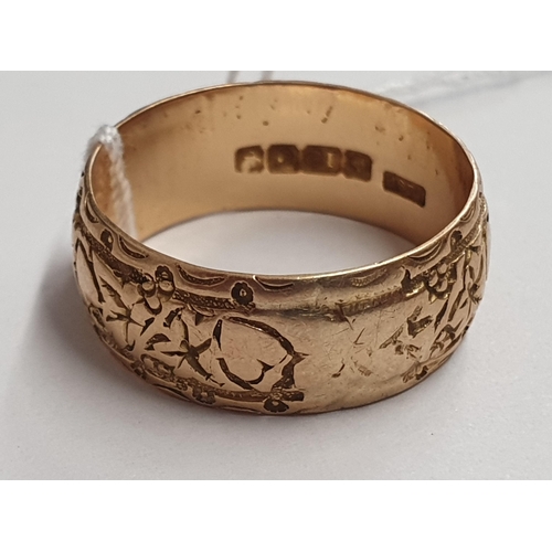 170 - An 18ct gold embossed Wedding Band, ring size P/Q, approx 5.60gms and a small filigree Cross set rou... 