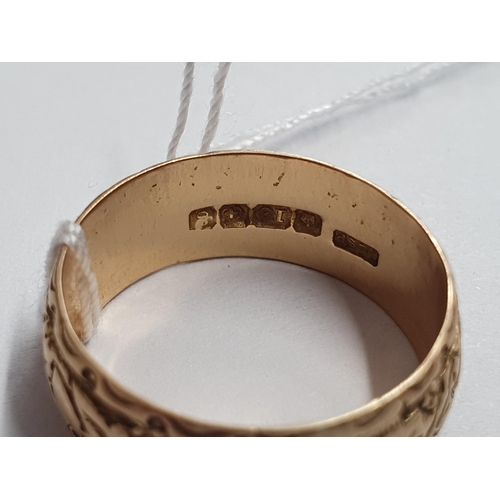 170 - An 18ct gold embossed Wedding Band, ring size P/Q, approx 5.60gms and a small filigree Cross set rou... 