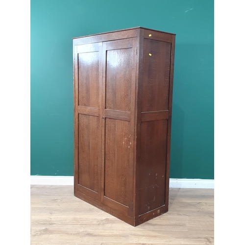 24 - A Heals oak Press Cupboard the pair of panelled doors enclosing four fitted shelves, with inset ivor... 