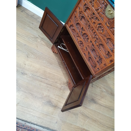 31 - A Chinese carved hardwood Cutlery Stand with hinged top and with fitted drawers and pair of cupboard... 