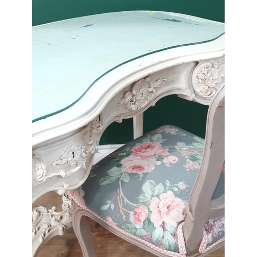 35 - A white painted Dressing Table with heavily carved floral and scroll design fitted frieze drawer, 3f... 