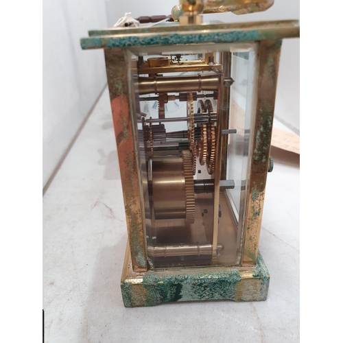 370 - Two brass cased Carriage Clocks and four old metal Flat Irons, (R5)