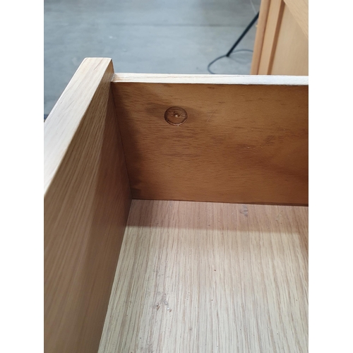 38 - A modern light oak Sideboard fitted three drawers flanked by a pair of cupboard doors, 5ft 2in W x 2... 