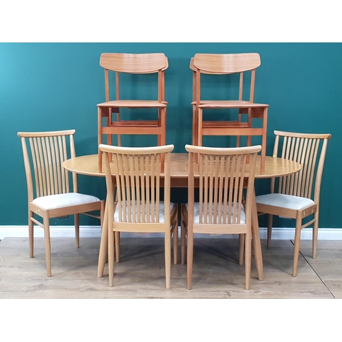 39 - A light oak extending oval Dining Table and four Chairs with slatted backs and turned supports, 5ft ... 