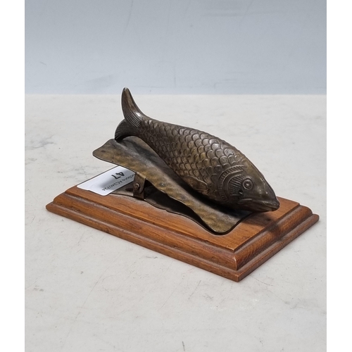 47 - A Paper Clip in the form of a brass fish on oak base, 4 1/2in, (R9)