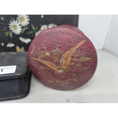 51 - Three papier mache Boxes floral painted on a black ground, and a red ground cylindrical Box decorate... 