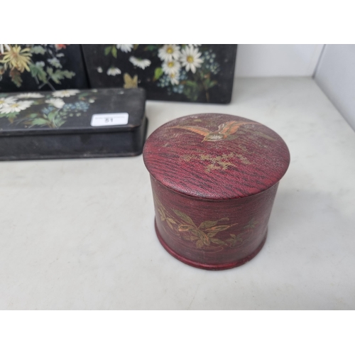 51 - Three papier mache Boxes floral painted on a black ground, and a red ground cylindrical Box decorate... 