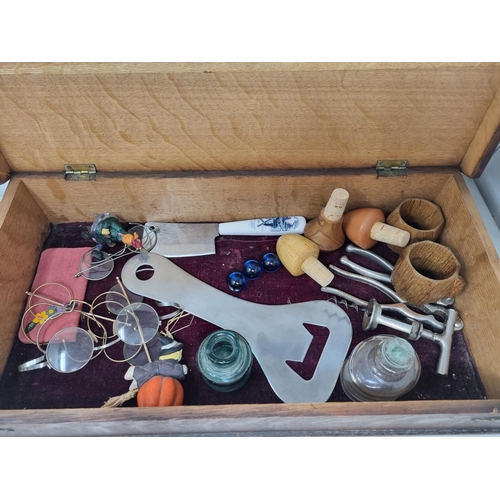 53 - An oak Box containing Spectacles, Corkscrew, Bottle Opener, glass Inkwells, Nut Crackers, Aldis Proj... 