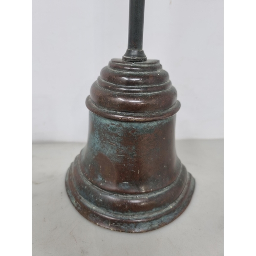 57 - A 19th century brass Doorstop of bell shape with loop handle, 16in (R2)