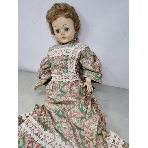 60 - A large Doll with moving eyes, wearing long floral pattern dress with embroidered friezes,  26in (R2... 