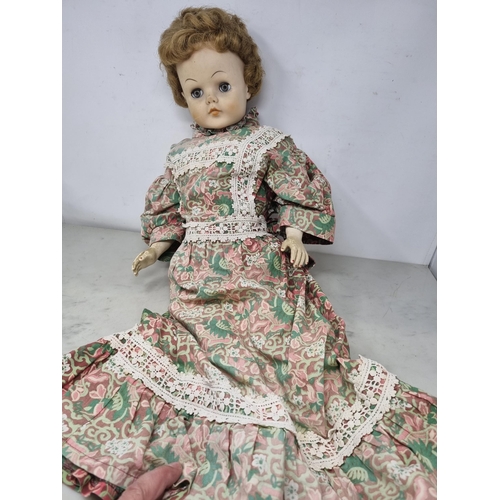 60 - A large Doll with moving eyes, wearing long floral pattern dress with embroidered friezes,  26in (R2... 