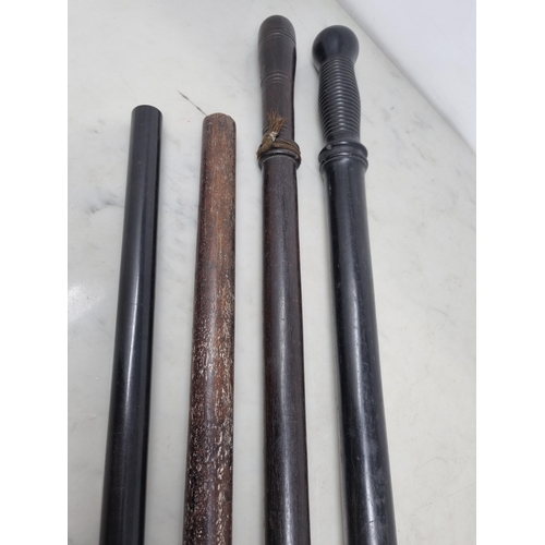 62 - Two 19th century Truncheons in ebony, etc with turned grips and metal tips, 32 and 29in, and two Pap... 