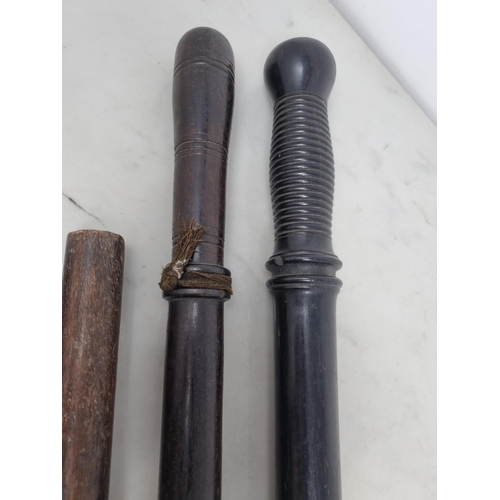 62 - Two 19th century Truncheons in ebony, etc with turned grips and metal tips, 32 and 29in, and two Pap... 