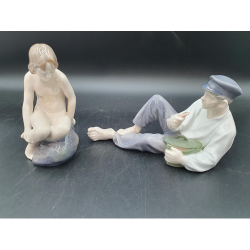 72 - A Royal Copenhagen Figure of a nude bather, No 4027, and another of youth holding heart, No 865 (R1)