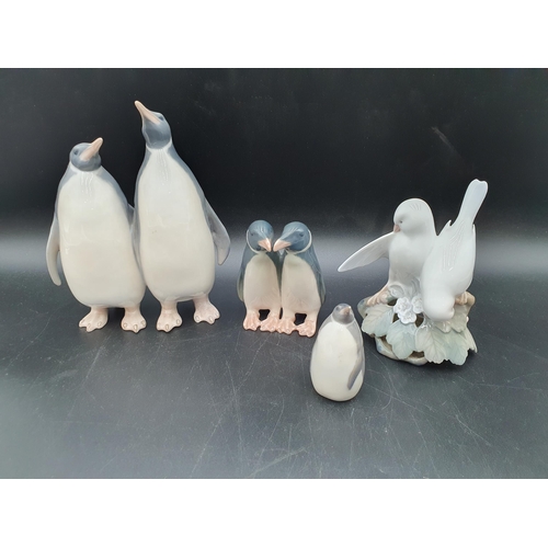 74 - Two pairs of Royal Copenhagen Penguins, 7in & 4in, No 1190 & 2148?, a single Penguin, No 3003, and a... 