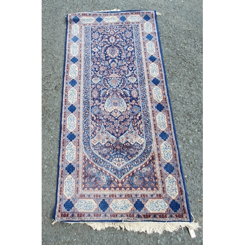 764 - A blue ground Rug with multi borders with central archway design with floral and leafage decorations... 