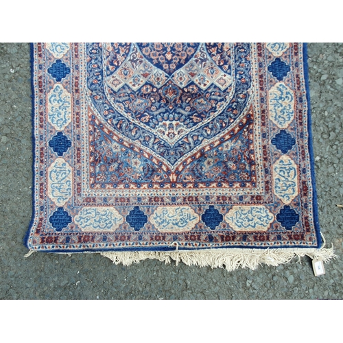 764 - A blue ground Rug with multi borders with central archway design with floral and leafage decorations... 