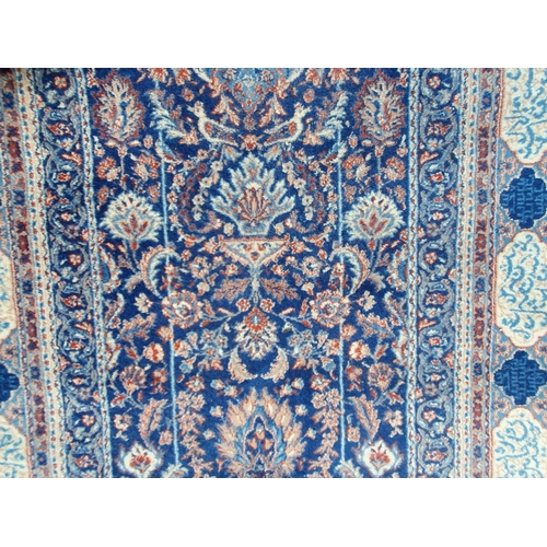 764 - A blue ground Rug with multi borders with central archway design with floral and leafage decorations... 